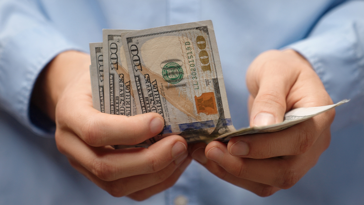 Man counting 100 US dollar bills in close-up. Investment or investor concept for wealth building, financial planning or income. Investor counting money.