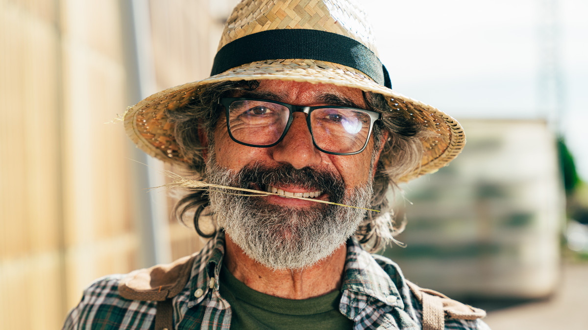 Farmer senior man working in his farm and greenhouse. Concept about agriculture, farn industry, and healthy lifestyle during seniority age.