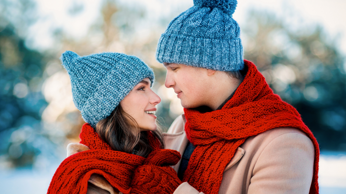 Couple Enjoying Winter Moments Together While Wearing Matching Hats and Scarves.