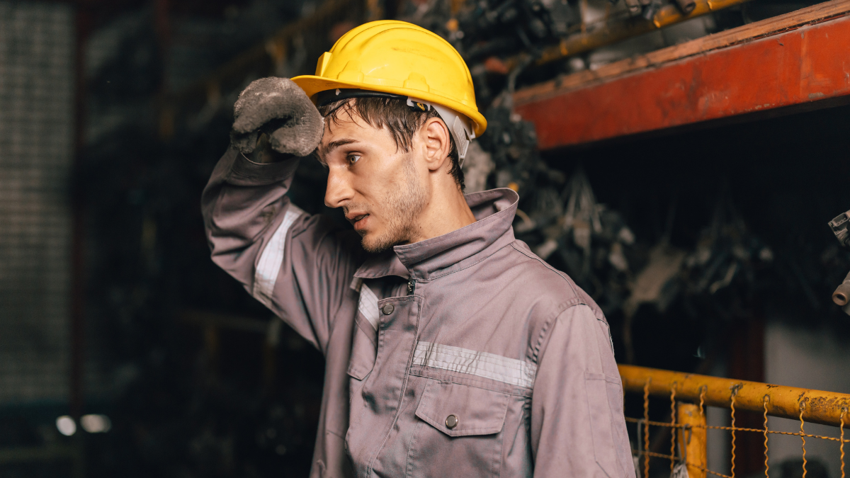 Tired fatigue exhausted engineer feel sick worker from hard working in factory sweat hot bad airflow workplace.