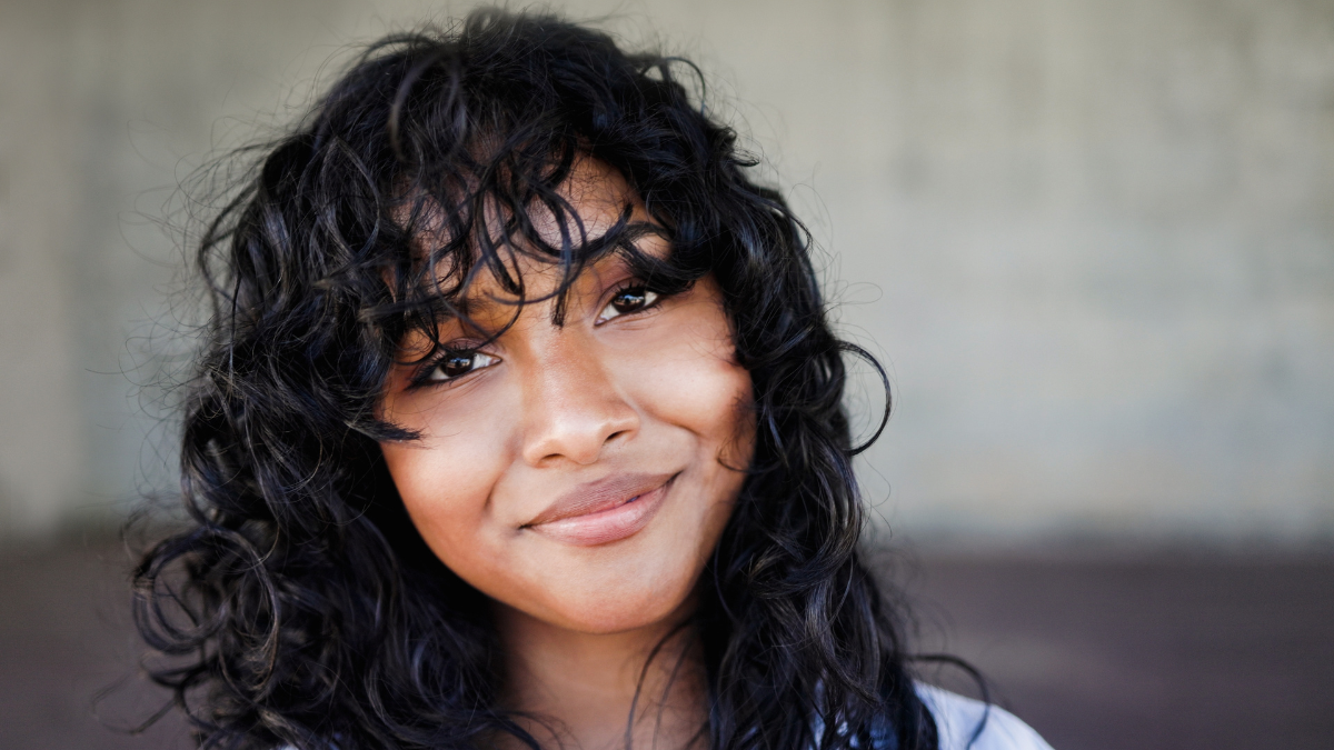 Happy Latin woman smiling in front of camera - Young female lifestyle concept.