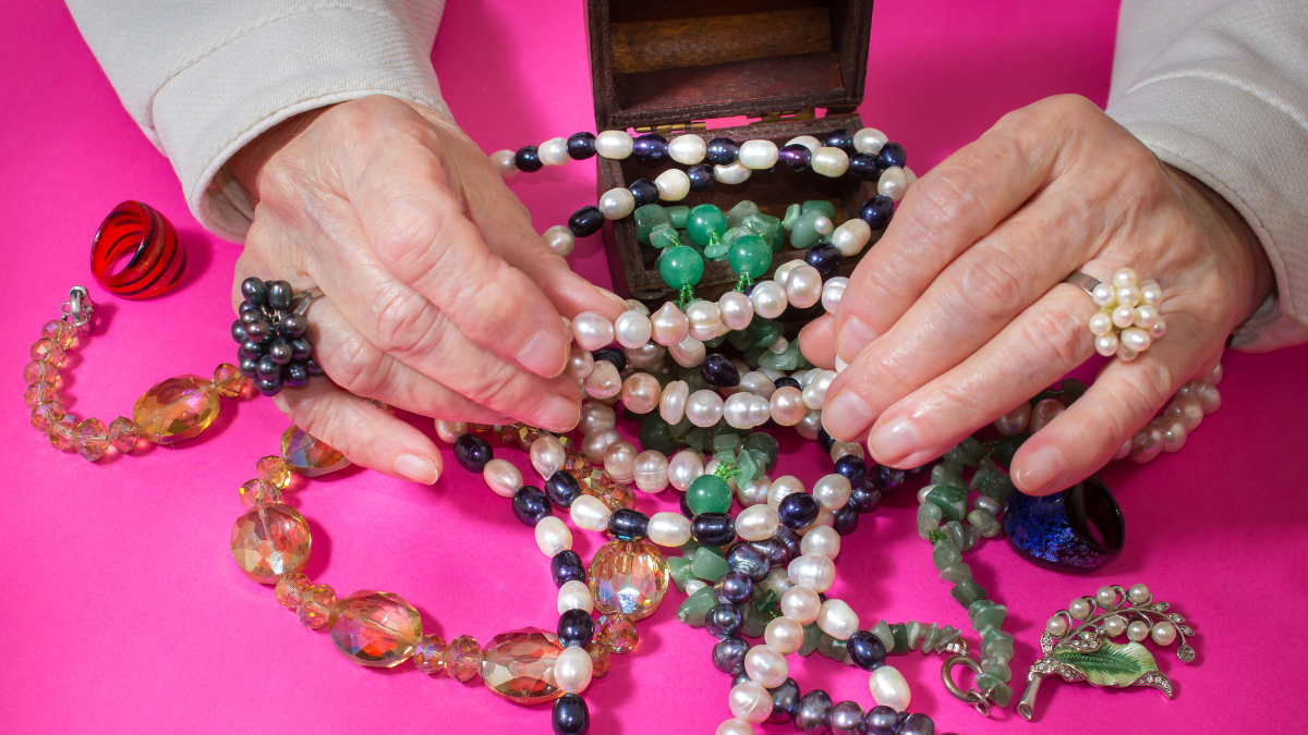 Senior woman and jewelry pearl. Antique Jewelry Box.