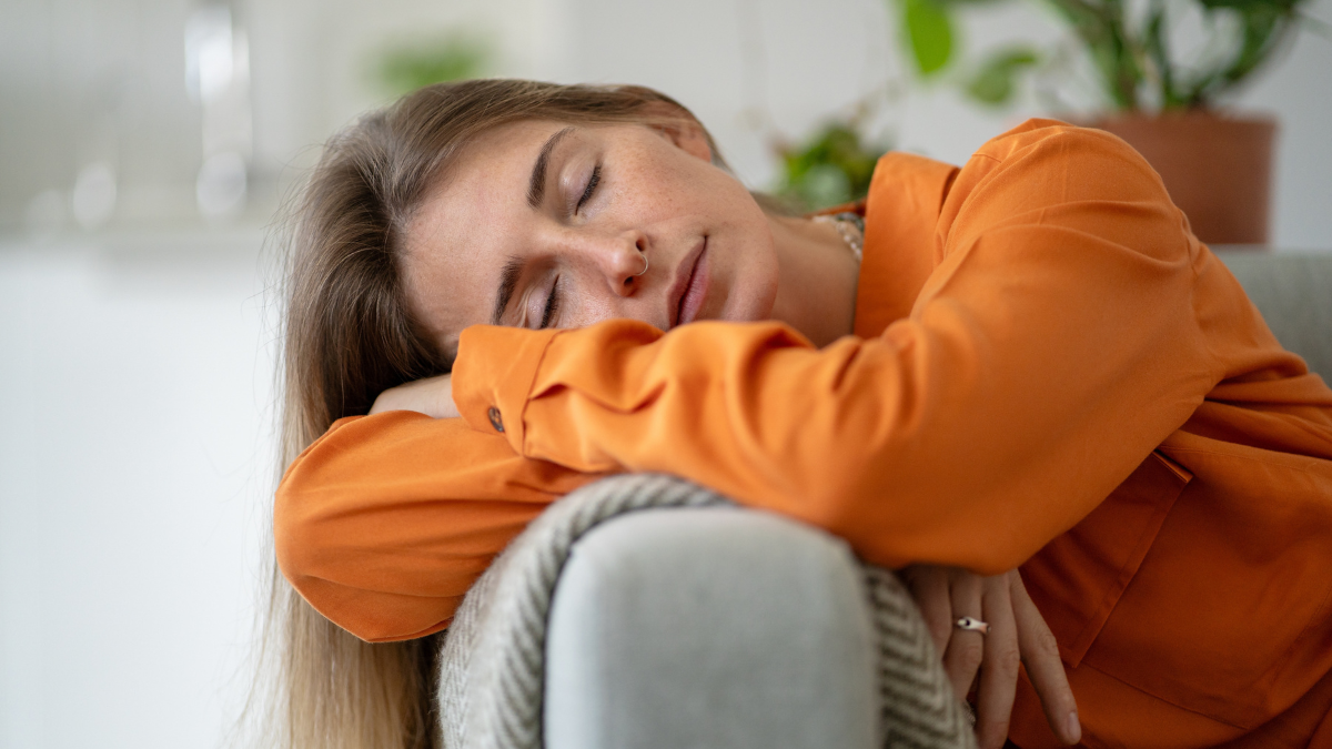 Middle-aged woman deeply tired and asleep on home sofa born from emotional exhaustion and chronic fatigue caused by intense inner experiences, stress or prolonged worry needs for rest and recovery. Easy Money Ideas.