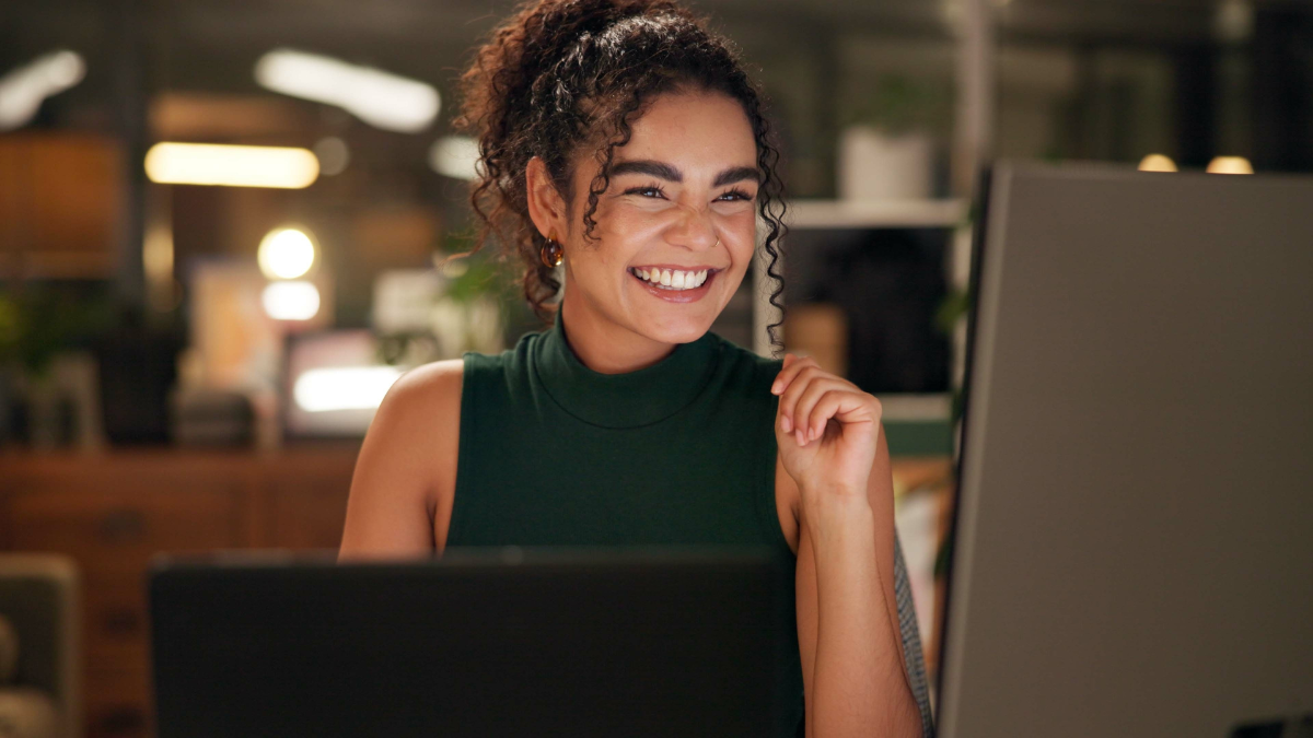 Happy, computer and success with business woman in office for magazine layout, art director and client approval. Media feedback, creative project and good news with person in design agency at night Money-Making Opportunities.