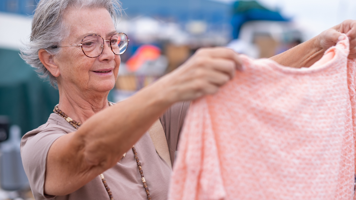 Senior woman at the flea market looking for second hand clothes, shoes, bags, jewellery. Zero waste shopping, eco friendly concept, sustainable lifestyle. _Reasons You Should Barter Instead of Buying Goods.