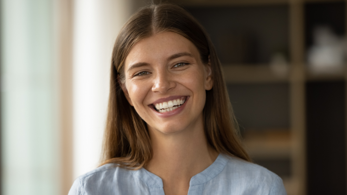 Close up head shot beautiful woman with natural beauty, wide smile and perfect skin no make up posing indoor staring at camera looks self-assured. Portrait of gorgeous young independent female concept automate your finances.