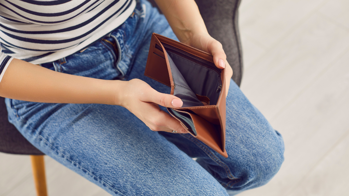 Woman opening empty wallet, poor person having no money in purse, bankrupt with financial problems. Low income or lacking budget, financial hardship, job loss, lack of planning, debt management debt payoff strategies.